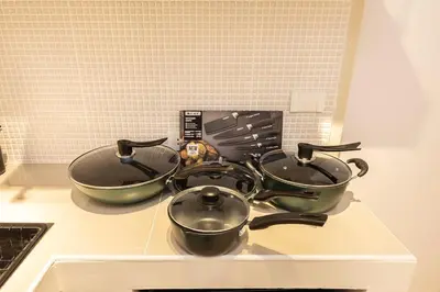 a stove top with three pots and pans on it at Cute & Comfy Studio for 3 guests at Center of Sathorn in Bangkok