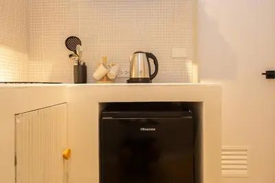 a kitchen with a counter top with a stove at Cute & Comfy Studio for 3 guests at Center of Sathorn in Bangkok