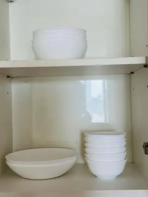 a shelf with bowls and plates on it at Page65-Bangkok Urban Light & City Rhythm -Ekkamai in Bangkok