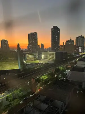 a city skyline at sunset with a highway at Page65-Bangkok Urban Light & City Rhythm -Ekkamai in Bangkok