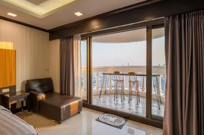 a hotel room with a bed and a balcony at Hangover State Tower Stunning River View in Bangkok