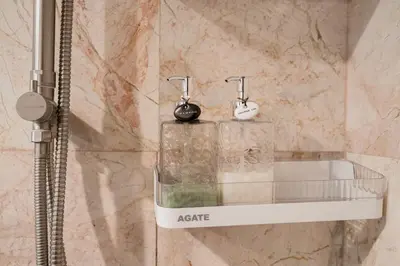 a bathroom with a shower with a sink and two faucets at Hangover State Tower Stunning River View in Bangkok