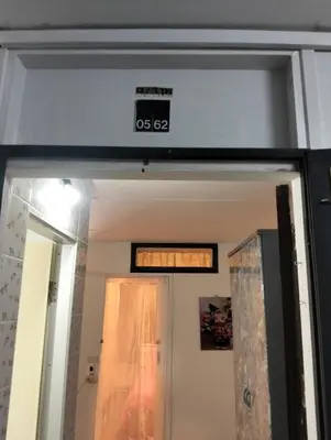 a clock on top of a door in a room at IMPACT popular condo แม่ตัง in Ban Bang Phang