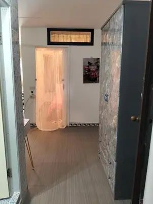 a hallway with an open door with a stone wall at IMPACT popular condo แม่ตัง in Ban Bang Phang