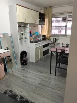 a kitchen with a table and a kitchen with a stove at IMPACT popular condo แม่ตัง in Ban Bang Phang