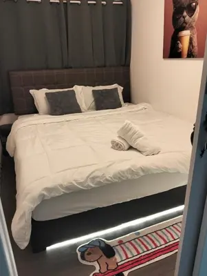 a bedroom with a bed with a dog on it at IMPACT popular condo แม่ตัง in Ban Bang Phang