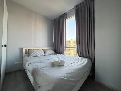 a bedroom with a bed with two white towels on it at Pano Ratchada 19 BKK MRT in Bangkok