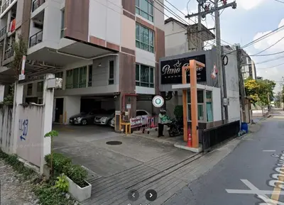 a building with a car parked in front of it at Pano Ratchada 19 BKK MRT in Bangkok