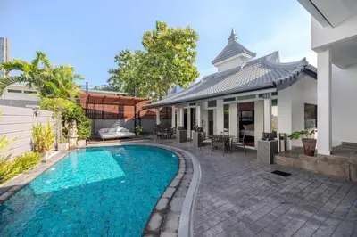 a swimming pool in front of a house at Thong Lo Private Pool Villa In Center Of Bangkok in Bangkok