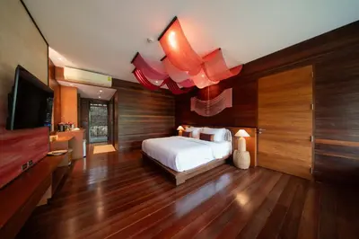 a bedroom with a bed and a flat screen tv at Baan Krai Nao The Riverfront in Bang Chak