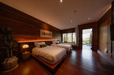 a bedroom with two beds and a large window at Baan Krai Nao The Riverfront in Bang Chak
