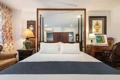 a bedroom with a large bed and a couch at Star House Classic Style in Bangkok