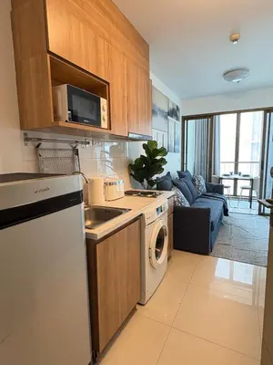 a kitchen with a sink and a dishwasher at Ideo Mix Sukhumvit 103, right next to BTS Udomsuk in Phra Khanong
