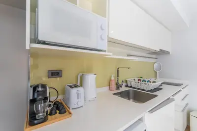 a kitchen with a sink and a microwave at Heart \u7d20\u5764\u903836 Chewaheart Sukhumvit 36 in Bangkok