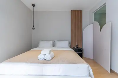 a bedroom with a bed with two towels on it at Heart \u7d20\u5764\u903836 Chewaheart Sukhumvit 36 in Bangkok