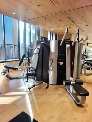 a gym with cardio equipment in a large room at Lux Condo 2BR - 5 mins walk to BTS Phrom Phong in Bangkok