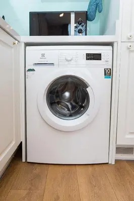 a white washing machine sitting in a kitchen at Lux Condo 2BR - 5 mins walk to BTS Phrom Phong in Bangkok