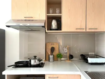 a kitchen with a stove top oven in a kitchen at Cozy style 2BR 2B near street food in city in Bangkok