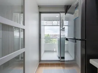 a kitchen with a glass door leading to a balcony at Cozy style 2BR 2B near street food in city in Bangkok