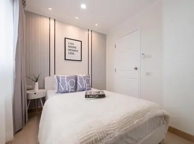 a white bedroom with a bed and a white closet at Cozy style 2BR 2B near street food in city in Bangkok