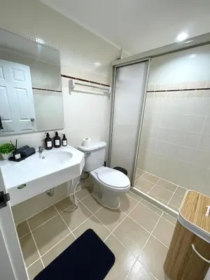 a bathroom with a toilet and a sink and a shower at Cozy style 2BR 2B near street food in city in Bangkok