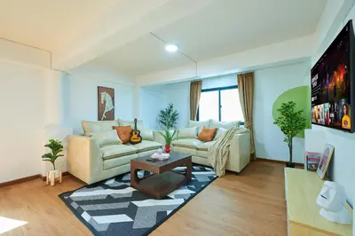 a living room with a couch and a table at Arta House in Bangkok