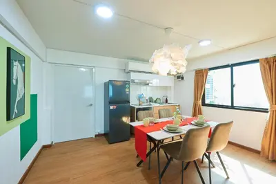 a kitchen and dining room with a table and chairs at Arta House in Bangkok