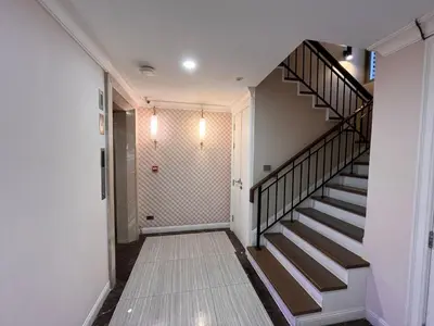 a hallway with a staircase in a house at Luxury Villa 4BR - 8 Mins to Thonglor BTS in Bangkok