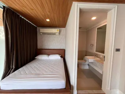a small bedroom with a bed and a bathroom at Luxury Villa 4BR - 8 Mins to Thonglor BTS in Bangkok