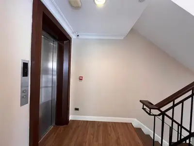 an empty hallway with a staircase and a door at Luxury private swimming pool house for 10pax in Bangkok