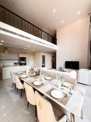 a dining room with a long table and chairs at Luxury private swimming pool house for 10pax in Bangkok