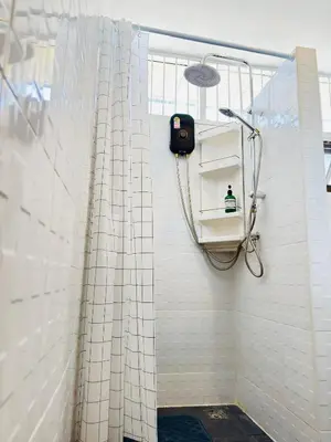 a shower with a shower curtain in a bathroom at King Room + Fast Wi-Fi • Ekkamai BTS Nearby in Khlong Toei