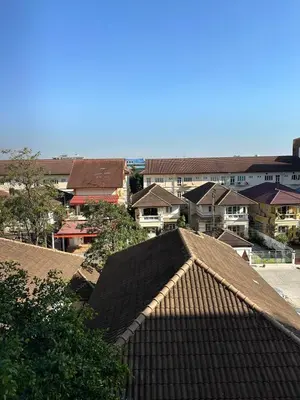 a view of a city with houses and roofs at Cozy Studio near Train Night market & BKK Airport in Bangna
