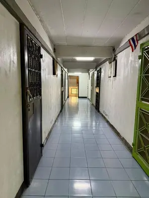 an empty hallway with a door in a building at Cozy Studio near Train Night market & BKK Airport in Bangna