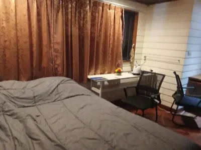 a bedroom with a bed and a desk and a deskablish at Spacious City-View Apartment with Modern Amenities in Krung Thep in Amphoe Phra Khanong
