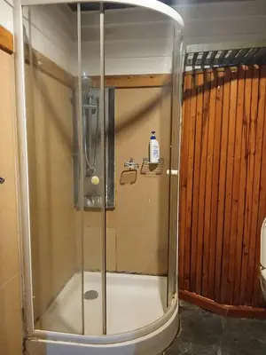 a shower with a glass door in a bathroom at Spacious City-View Apartment with Modern Amenities in Krung Thep in Amphoe Phra Khanong