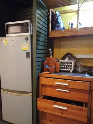 a kitchen with a refrigerator and a microwave at Spacious City-View Apartment with Modern Amenities in Krung Thep in Amphoe Phra Khanong