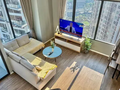 a living room with a couch and a flat screen tv at Bangkok Rama9 Cassia & Siamese in Bangkok