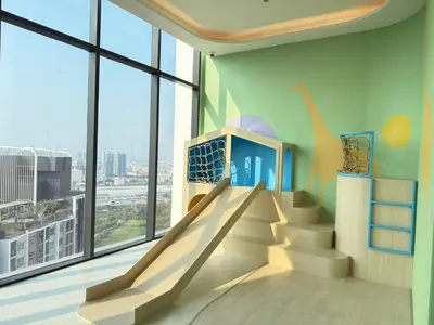 a skate park with a slide in a room with windows at Bangkok Rama9 Cassia & Siamese in Bangkok
