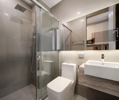 a bathroom with a toilet and a sink and a shower at Hampton Residence Phayathai in Sathani Sam Sen