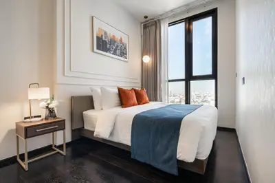a bedroom with a large bed and a window at Hampton Residence Thonglor in Khlong Toei