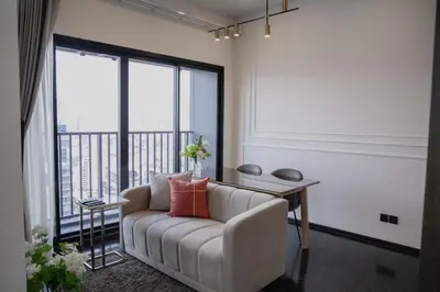 a living room with a couch and a table at Hampton Residence Thonglor in Khlong Toei