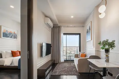 a living room with a bed and a couch and a table at Hampton Residence Thonglor in Khlong Toei