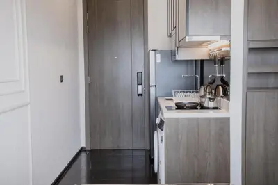 a small kitchen with a sink and a refrigerator at Hampton Residence Thonglor in Khlong Toei