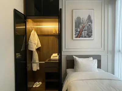 a hotel room with a bed and a closet at Hampton Residence Thonglor in Khlong Toei