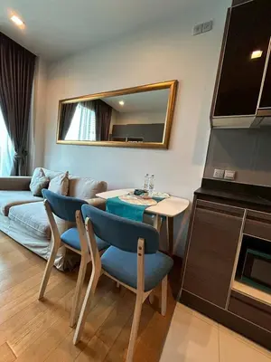 a living room with a couch and a table and chairs at Thonglor BTS Prime Pool gym Netflix city in Bangkok