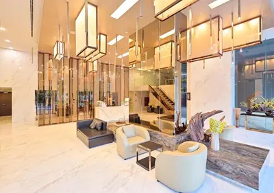 a lobby of a building with a couch and chairs at Thonglor BTS Prime Pool gym Netflix city in Bangkok