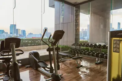 a gym with cardio equipment in a building at Thonglor BTS Prime Pool gym Netflix city in Bangkok