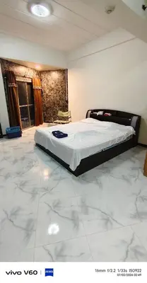 a large bed in a room with a marble floor at Mansion phram6 B in Bangkok