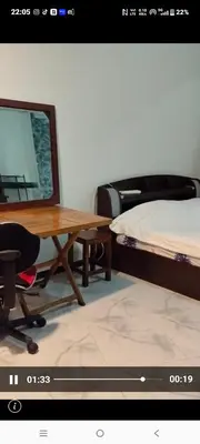 a table and a chair and a bed in a room at Mansion phram6 B in Bangkok